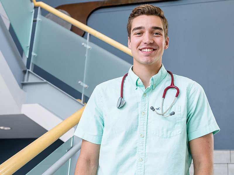 a Luther student with a stethoscope around his neck