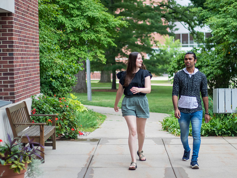 Luther College students walking down a sidewalk