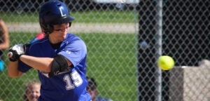 A Luther College softball player focuses in on the ball before she makes the hit.