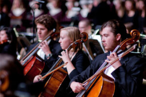 Luther students playing cello in the orchestra
