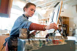 a Luther art student working on a painting