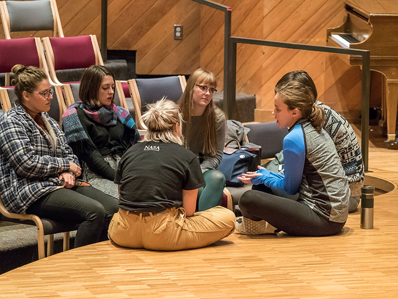 Six Luther students sitting in a circle having a conversation