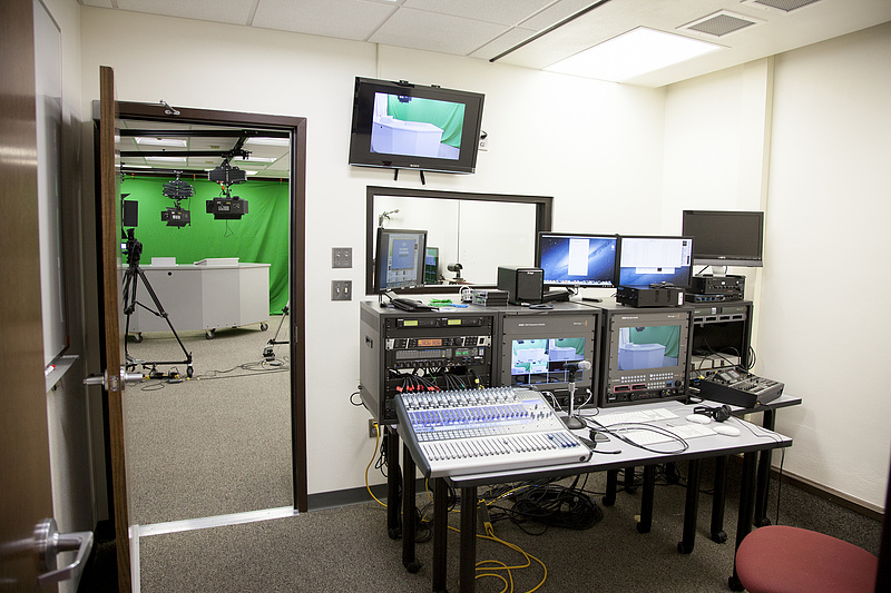 A picture of the control room in the Multimedia Studio. There are several control panels, monitoring