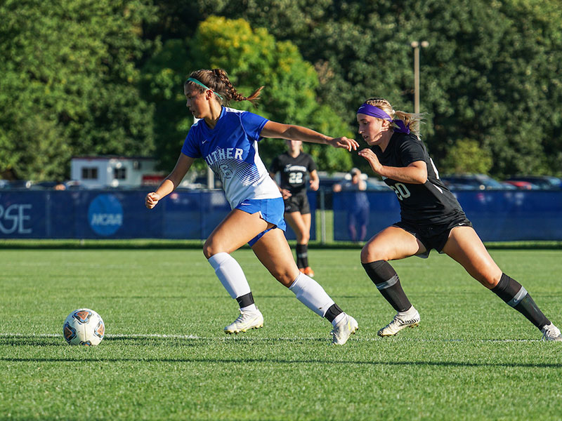 a Luther student-athlete kicking a soccer ball during a game