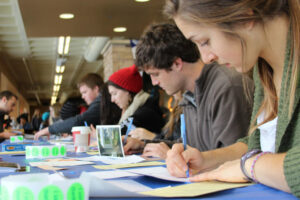 Luther students writing thank you notes to people who have donated to the college