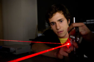 a Luther student performing an experiment with lasers