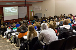 Luther students listening to a professor in a lecture hall