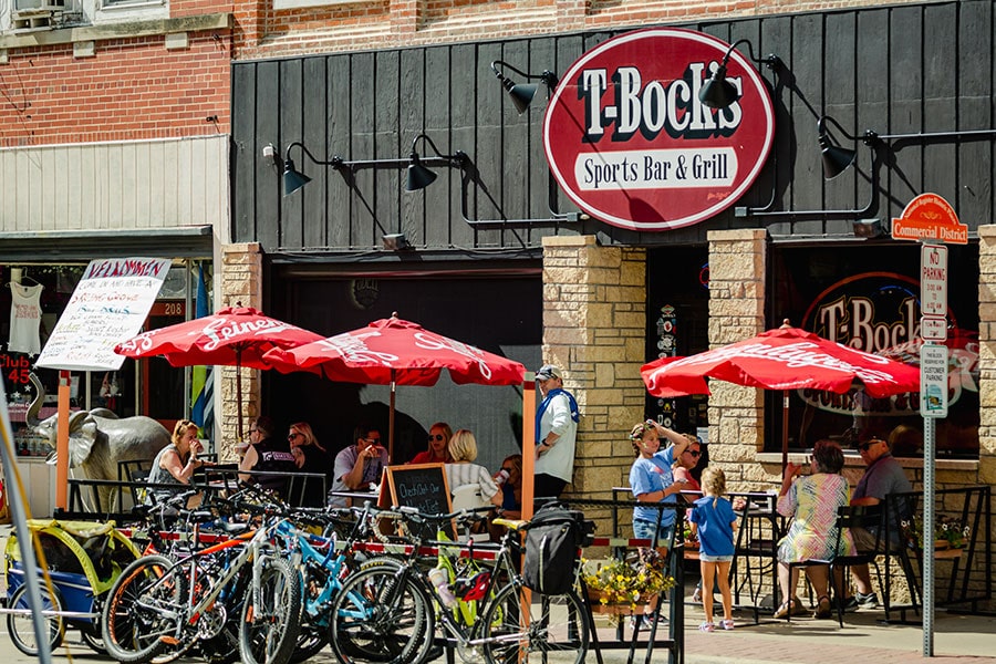 the entrance to T-Bock's Sports Bar & Grill, with customers eating at tables out front