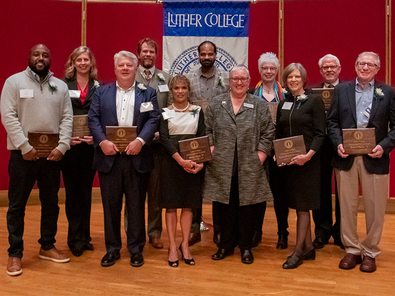 Photo of a group of Luther alumni holding award plaques