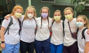 6 female students in masks, wearing nursing uniforms.
