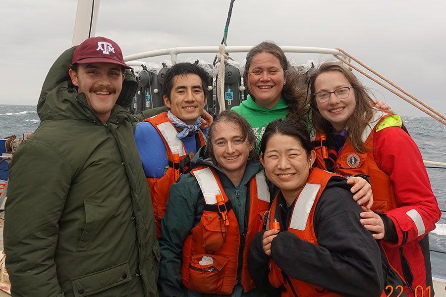 A group of five people onboard a boat