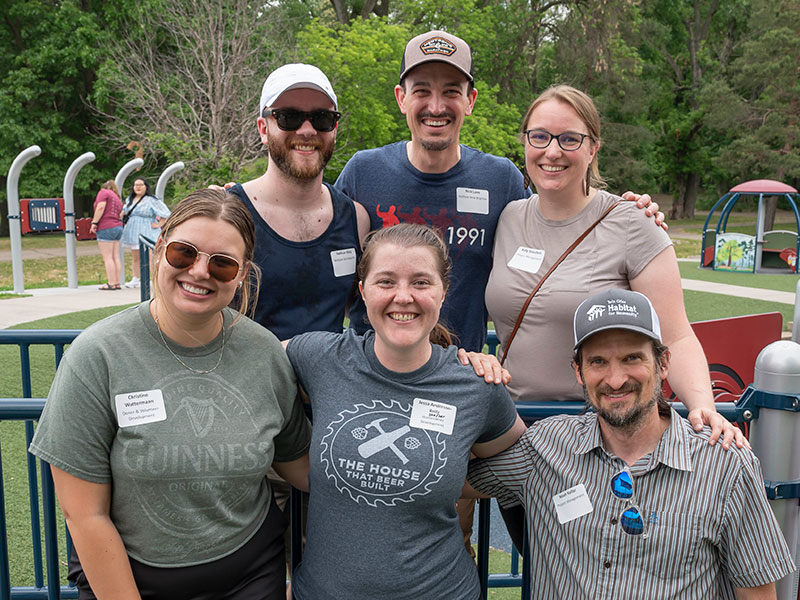 A group of six people standing in two rows outdoors