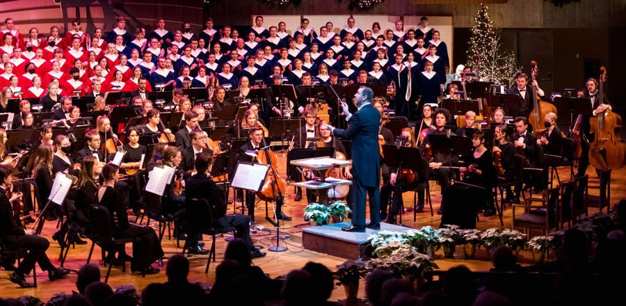 Choirs and orchestra performing on stage.