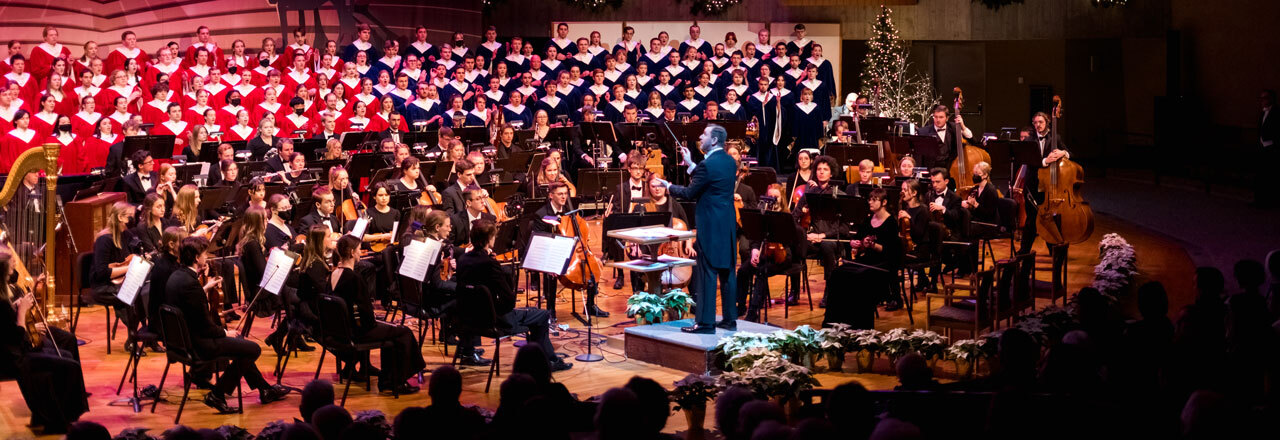 Choirs and orchestra performing on stage.