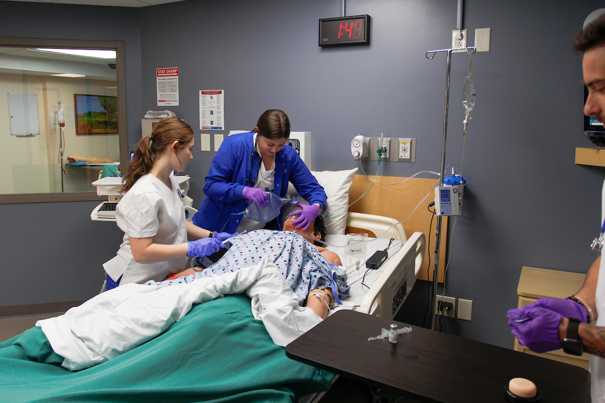 Luther College nursing students practicing CPR on a medical simulation doll.