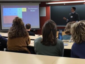 a professor leading a classroom full of students