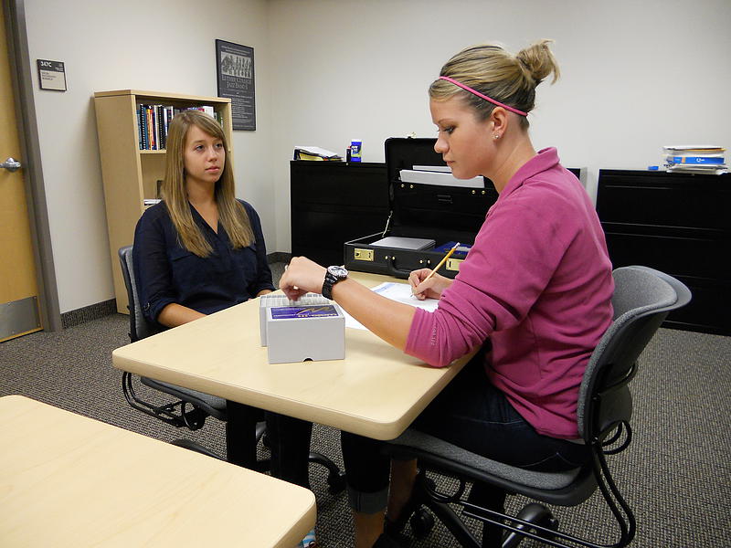 A Luther College student performing a psychological test for research.