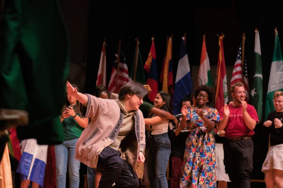 Students applaud a dancer on the stage of the CFL.