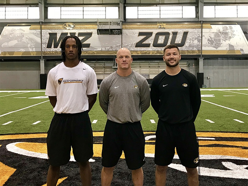 Dante Joseph, Adam Davis, and Del Ciucci standing on the Mizzou football field.