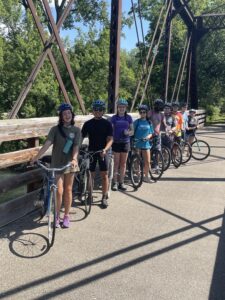 group picture accompanied by bikes and helmets