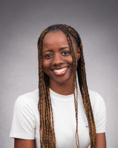 Esther Bitijula headshot against a gray background. 