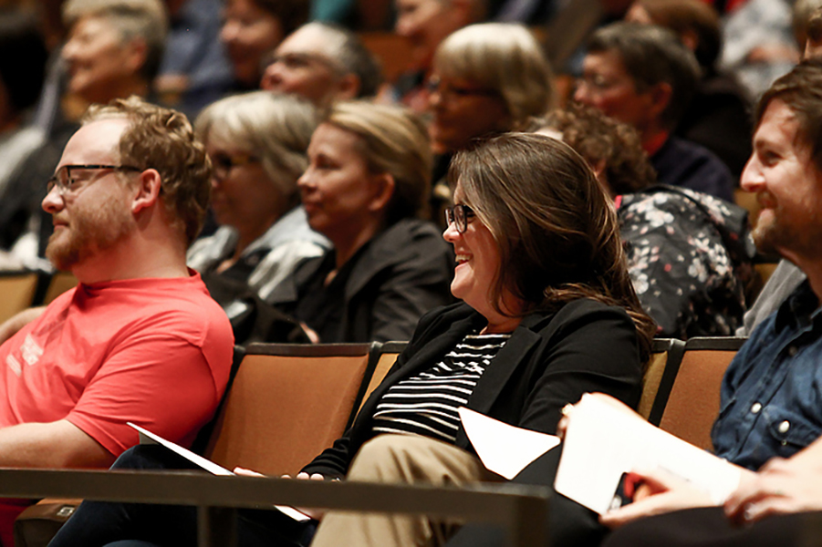 Attendees of the Luther College Writers Festival sitting in a theater listening to a presentation