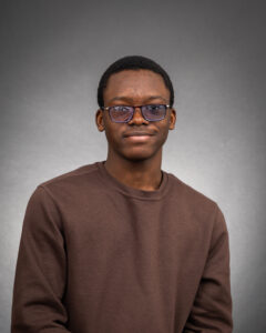 Mansur Kasali headshot against a gray background. 