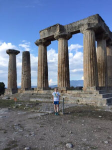 Megan Gmitro standing in front of ancient ruins in Greece