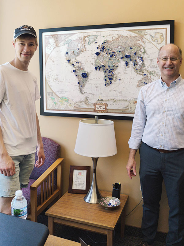 Two men standing in a yellow office