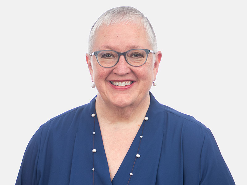 Headshot of a woman in a blue shirt