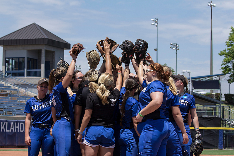 Luther's Softball team forms huddle before game starts