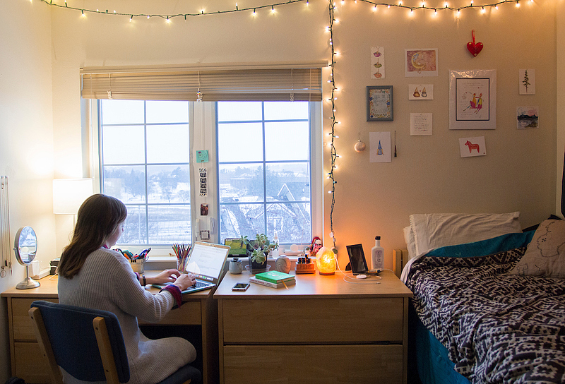 student studies in Baker Village home