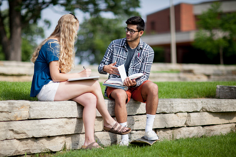 students sit outside in Bentdahl Commons