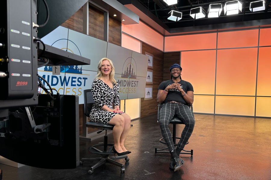 A TV host and Jaden Bilal sit in the studio.