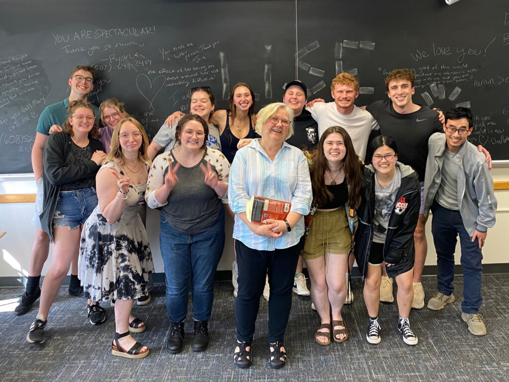 Lise Kildegaard stands with a classroom of students