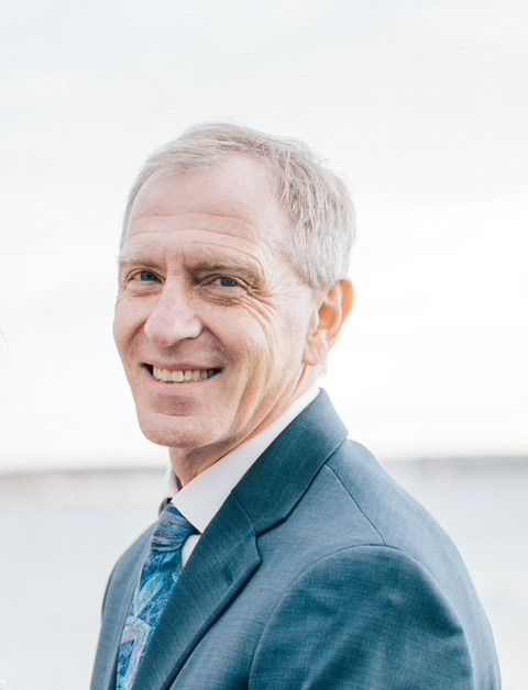 Head shot of a man in a blue suit