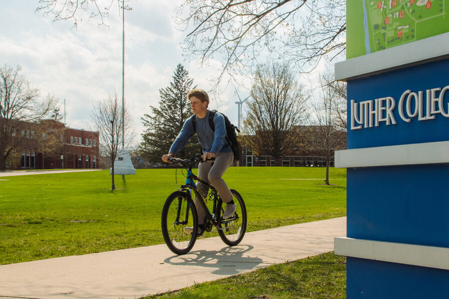 college student bikes to class at Luther College