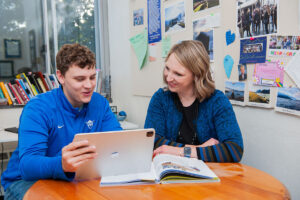 Professor Maren Johnson in her office with a student, looking at a laptop