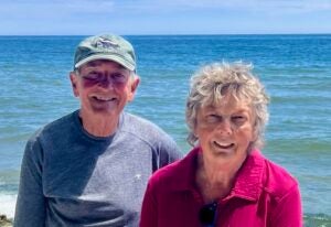 married couple with ocean in background