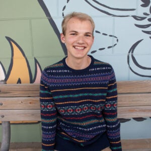 college student sitting and smiling