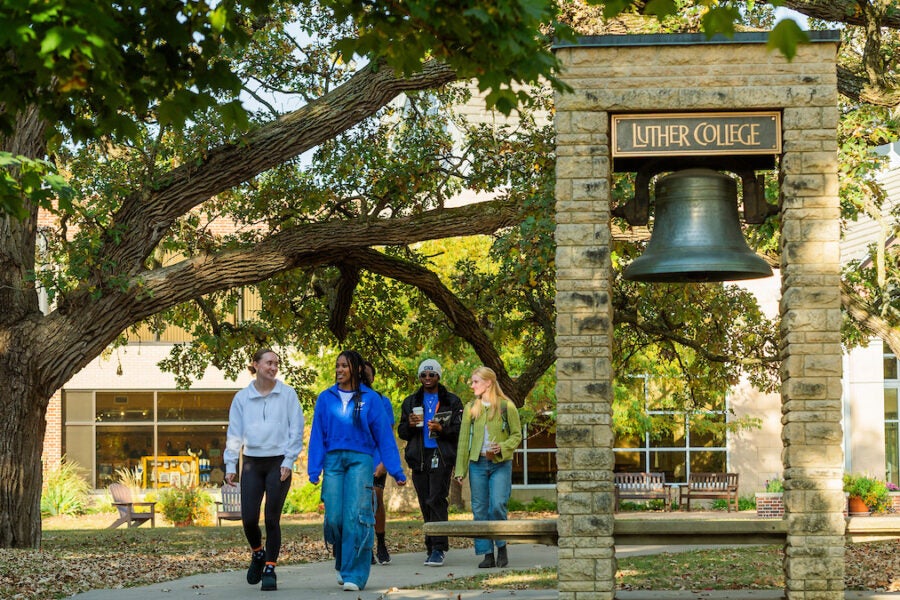 students walking by Luther bell
