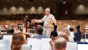 orchestra members look at conductor