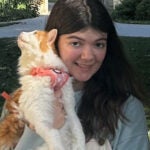 woman holds cat