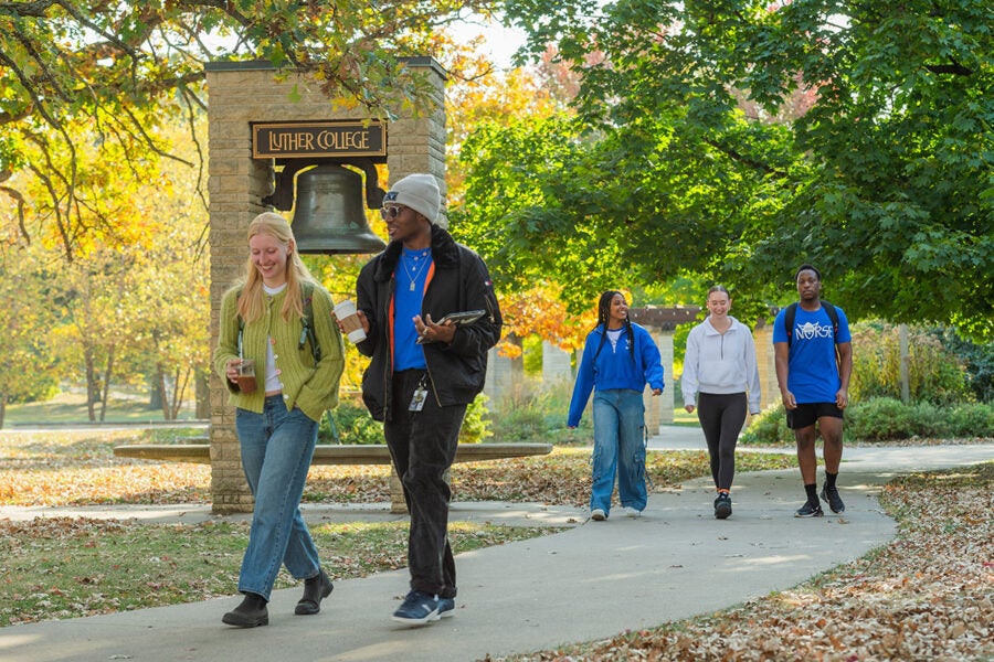 Five students walking across the Luther College campus.