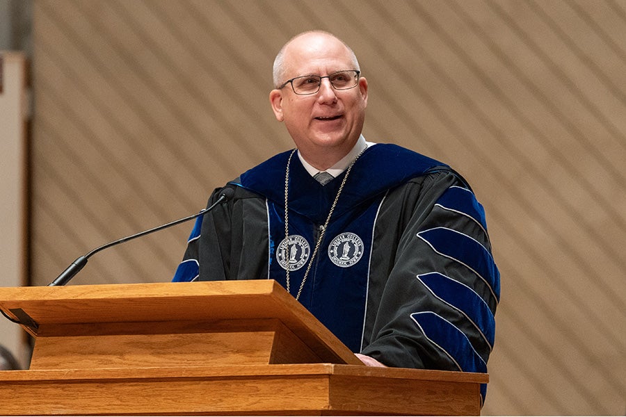 Brad Chamberlain speaks at a podium.