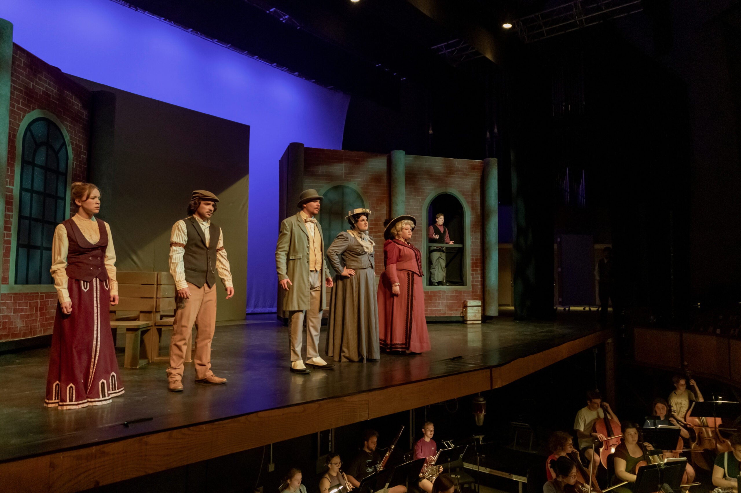Four Luther College students performing on stage in the opera Tour de Farce.