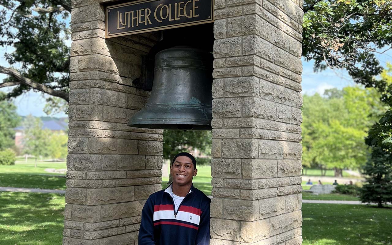 Geremiah Brown stands under the Luther Bell.