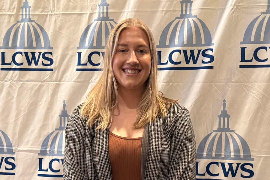 Kayla Will in front of an LCWS backdrop