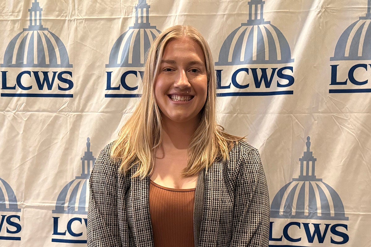 Kayla Will in front of an LCWS backdrop