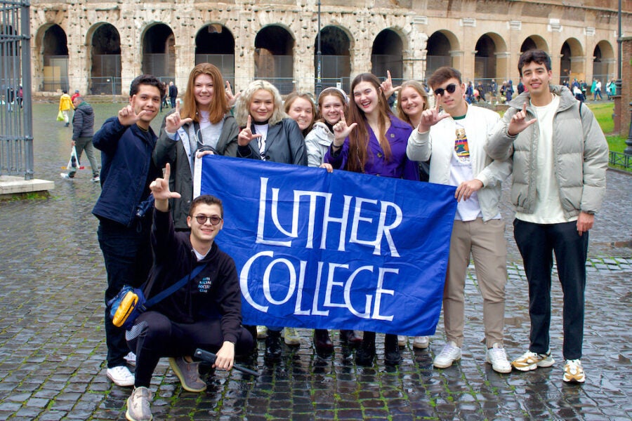 Luther College students stand with flag in Malta.